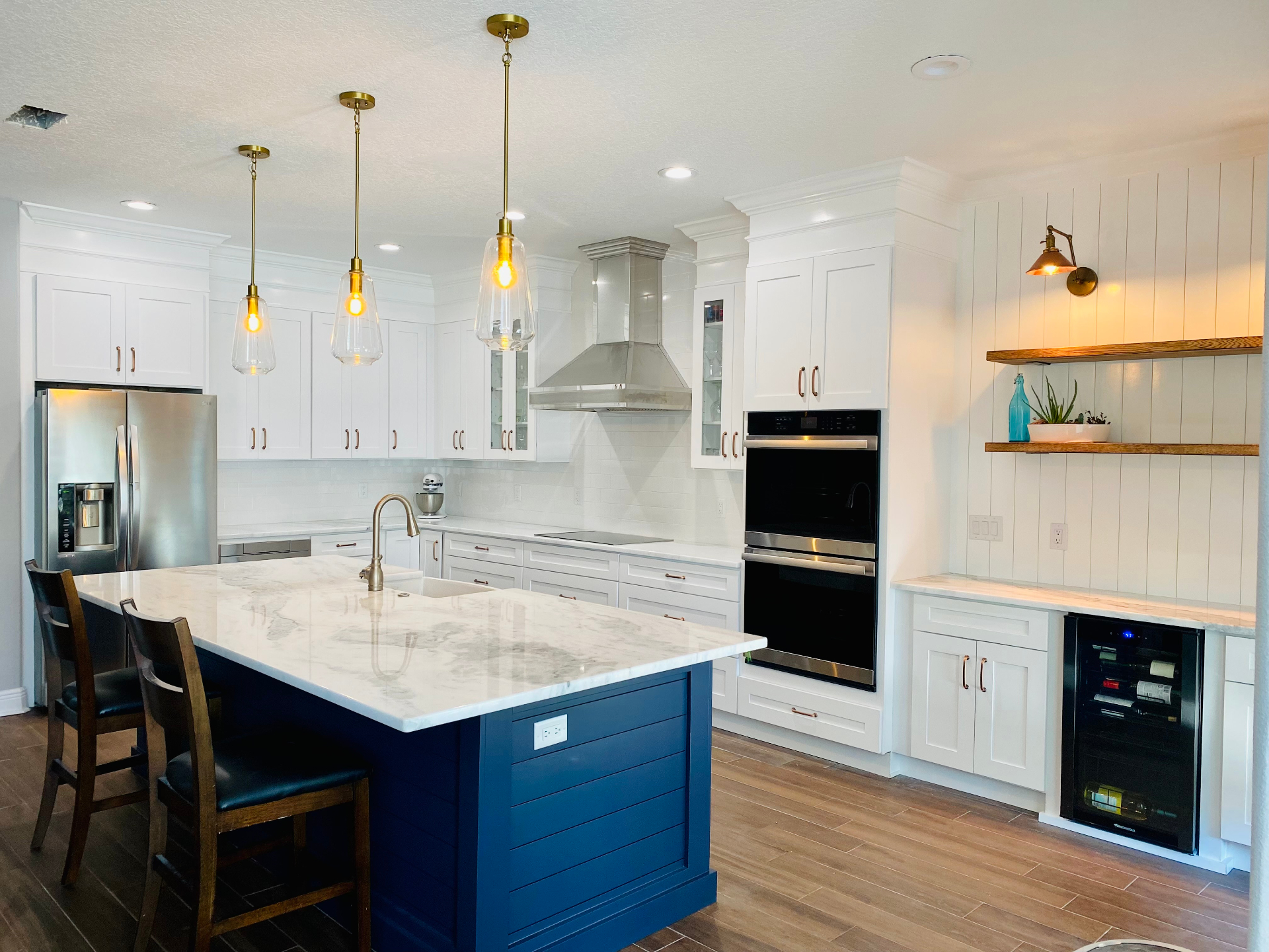 Luxury Florida kitchen with navy cabinetry and gold hardware